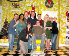 Evans (back row, fourth from left) and Hayes (center, seated) with the cast of Shear Madness
