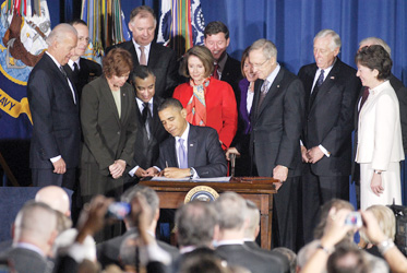 President Obama signing the DADT repeal law last December, which still awaits certification