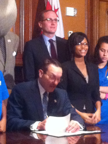 Mayor Vincent Gray (seated) signs Youth Bullying Prevention Act of 2012 into law