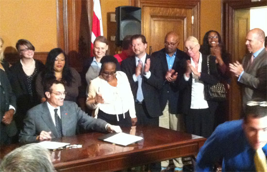 Surrounded by activists, Mayor Vincent Gray signed two pro-LGBT bills, the JaParker Deoni Jones Birth Certificate Equality Amendment Act and the Marriage Officiant Act, into law Tuesday afternoon.