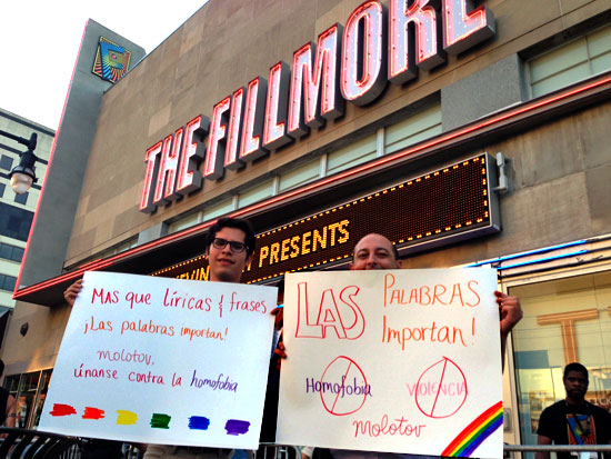 LGBT activists hold up signs protesting violent anti-gay lyrics of the Mexican rock band Molotov outside the band's concert Monday night at the Fillmore Silver Spring.  