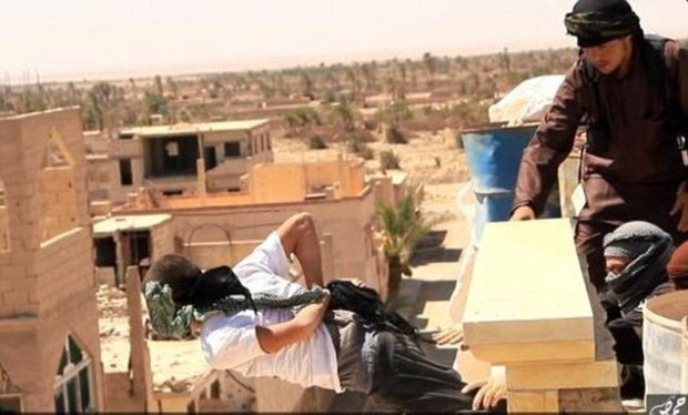 ISIS fighters push a man from a building, File Photo