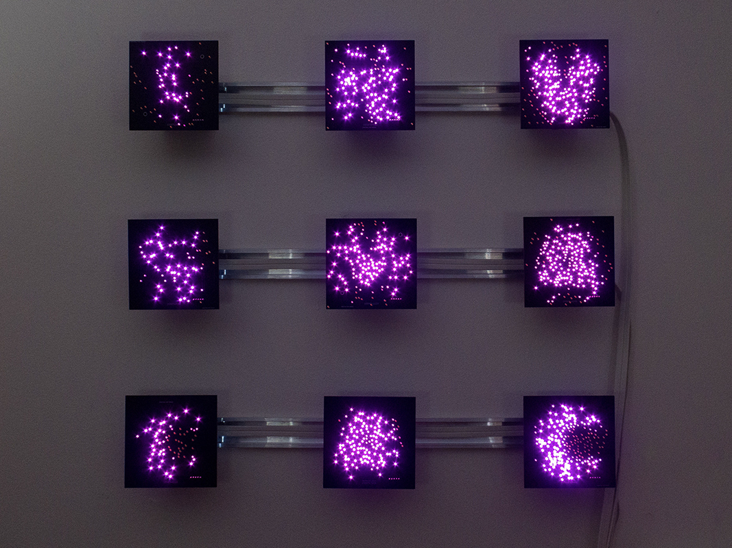 "Rxsqtta-Stzne"  by Chris Combs.Custom board, pink LED, computer, radio, motion sensor, algorithm, PLA, DIN rail