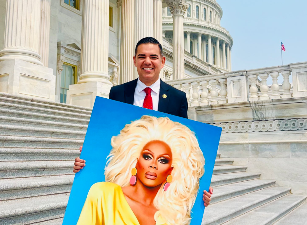 Congressman Robert Garcia holding a picture of RuPaul (instagram.com)