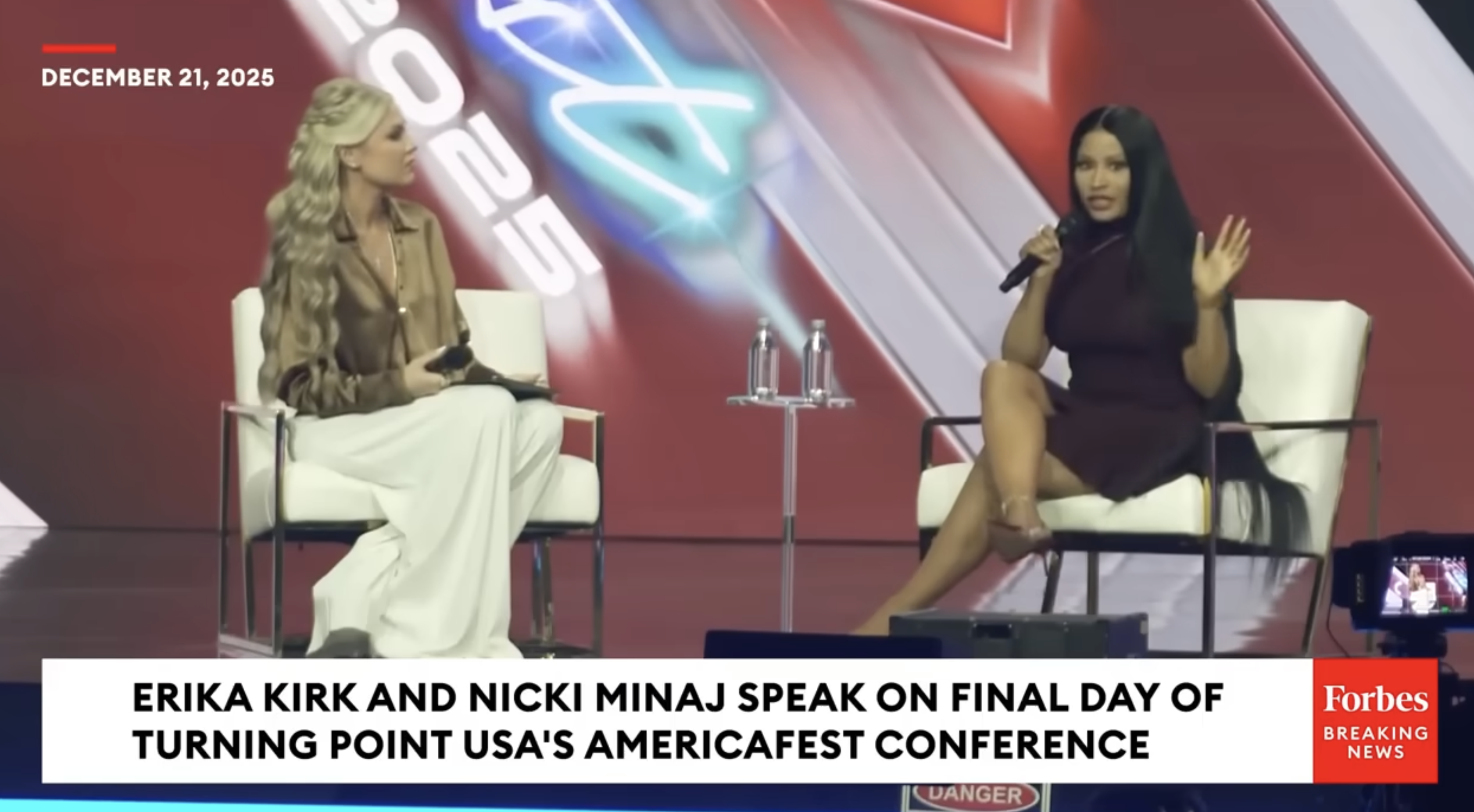 Nicki Minaj onstage with Erika Kirk at AmericaFest 2025 - Screenshot: Forbes